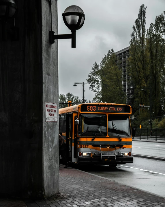 a school bus drives down a rainy street