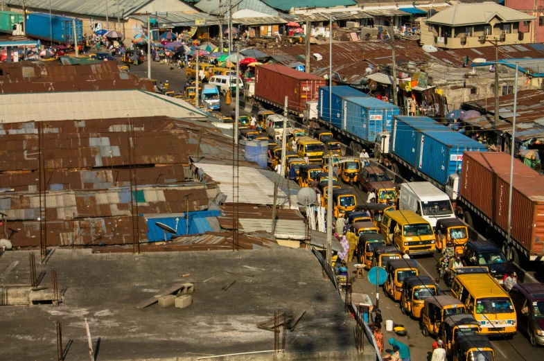 a train station with multiple rail cars, some yellow and blue