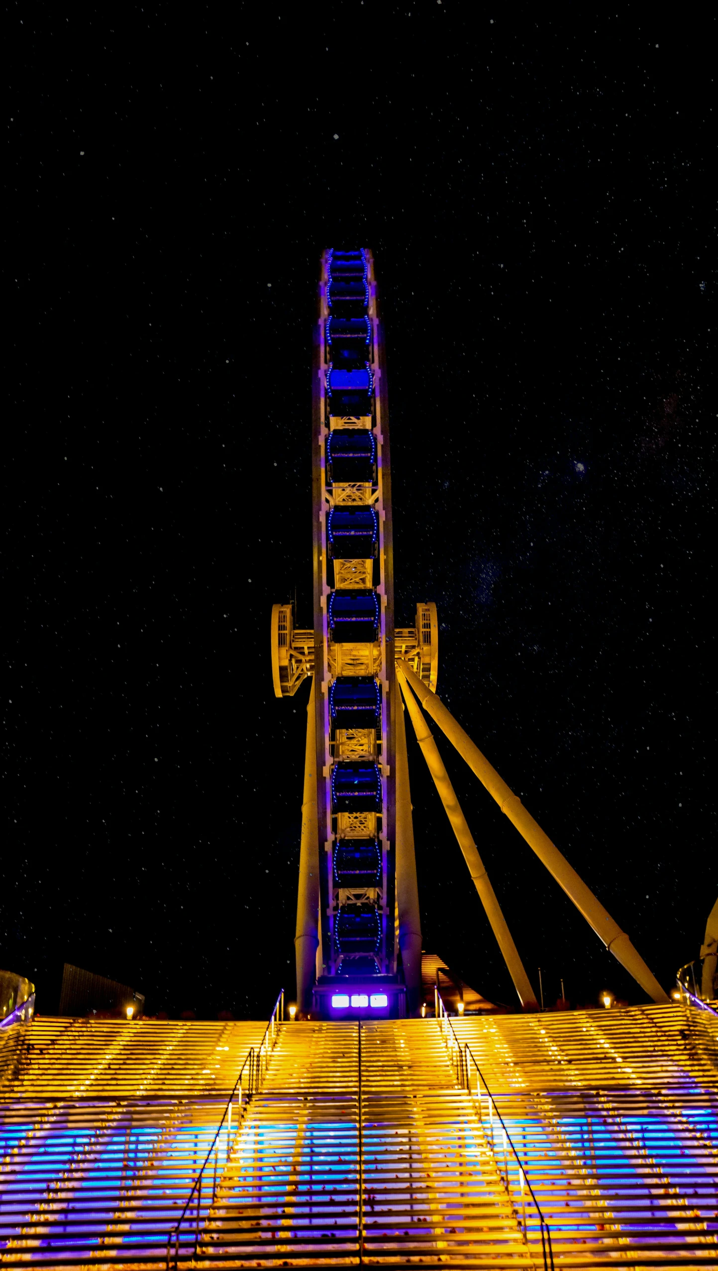 a ferris wheel lit up in the night sky