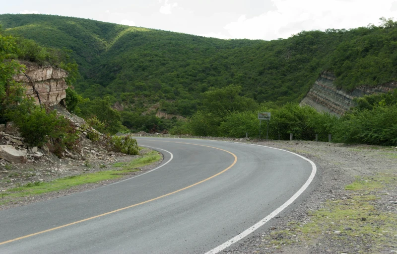 road curves to nowhere as seen from the side of a hill