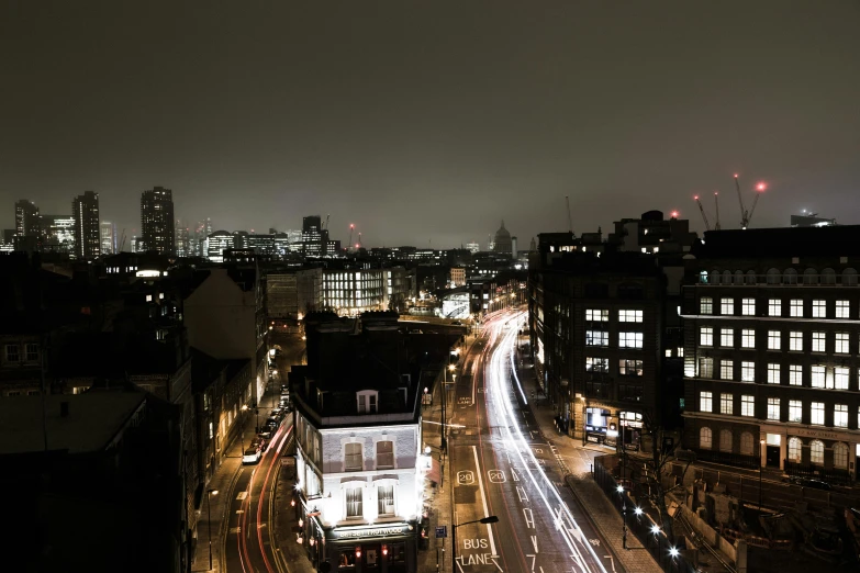 a city street with lots of buildings lit up at night