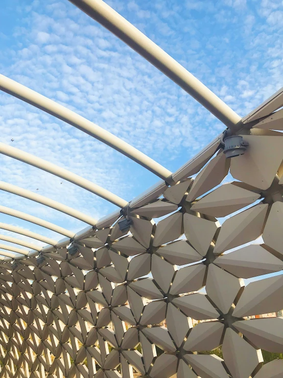 a canopy roof with curved metal bars suspended over it