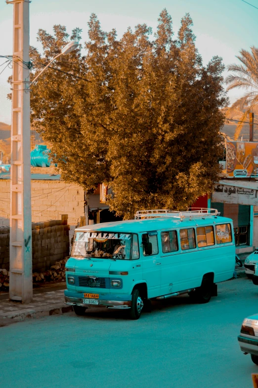 a blue bus on a city street