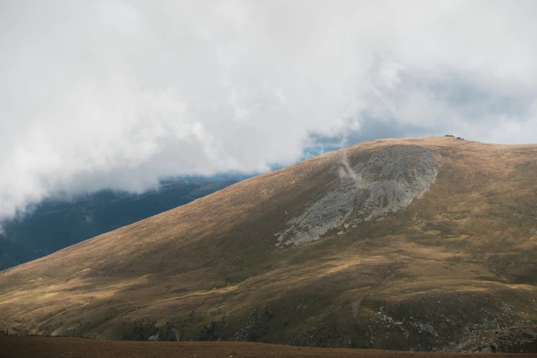 several people stand on the top of a mountain