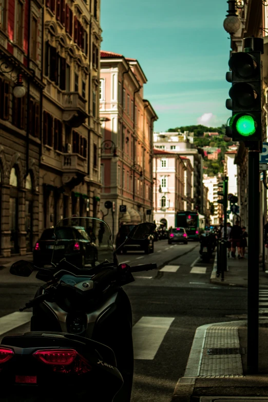 there is a motor bike that is stopped at the green light