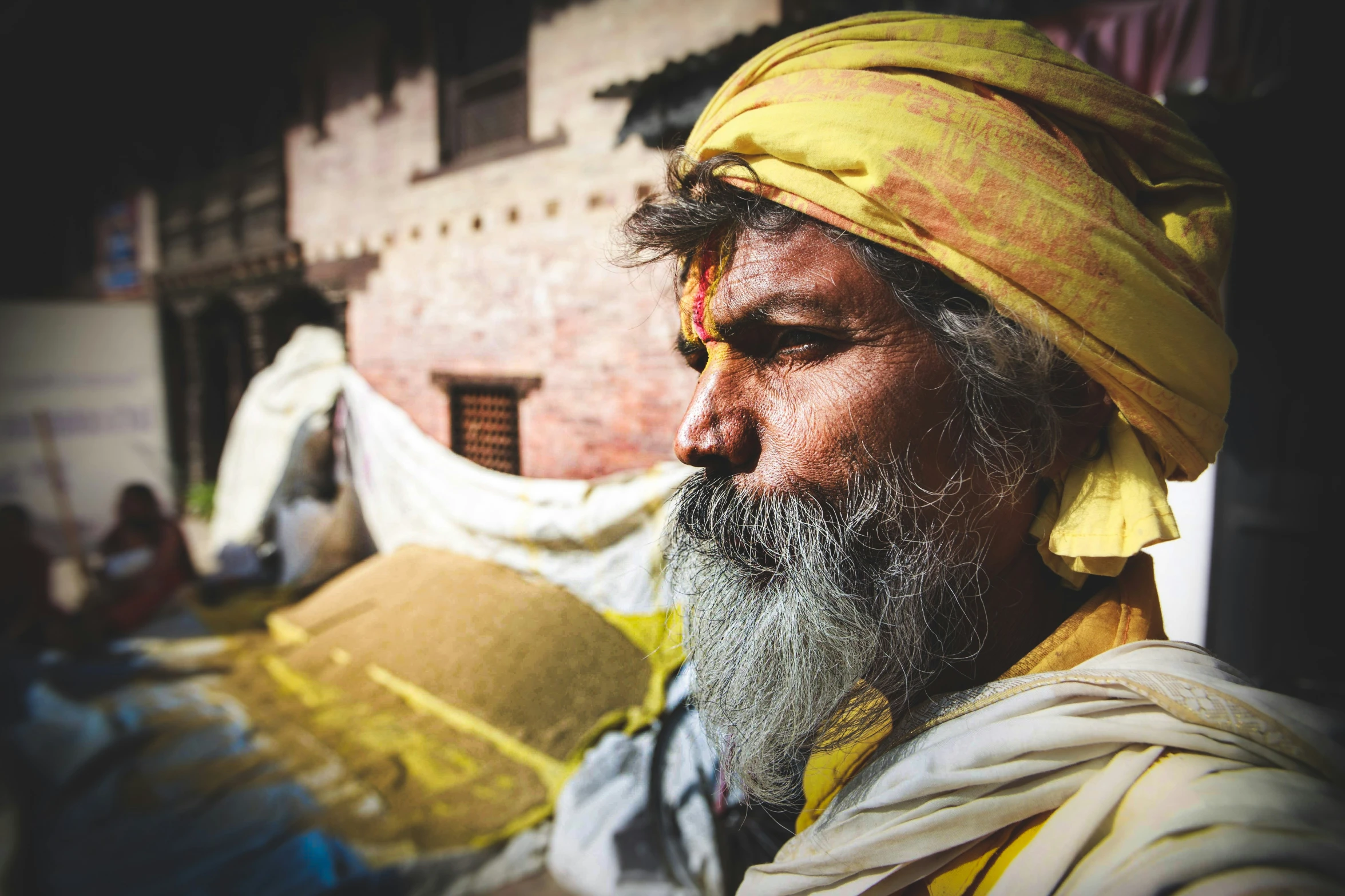 a man with a yellow headdress and red eyes