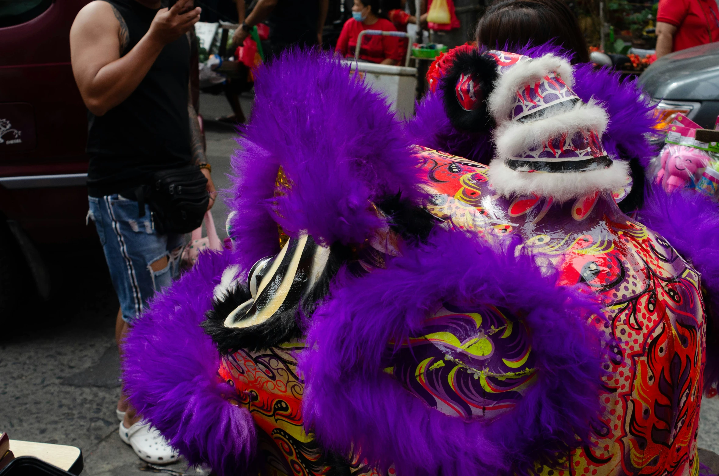 a purple dragon decoration is shown as it marches down the street