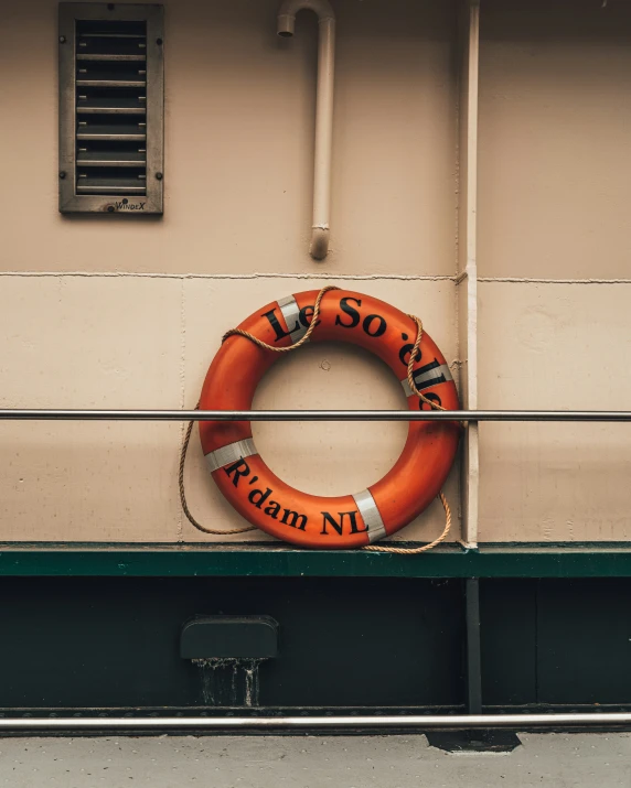 an orange life preserver on the side of a building