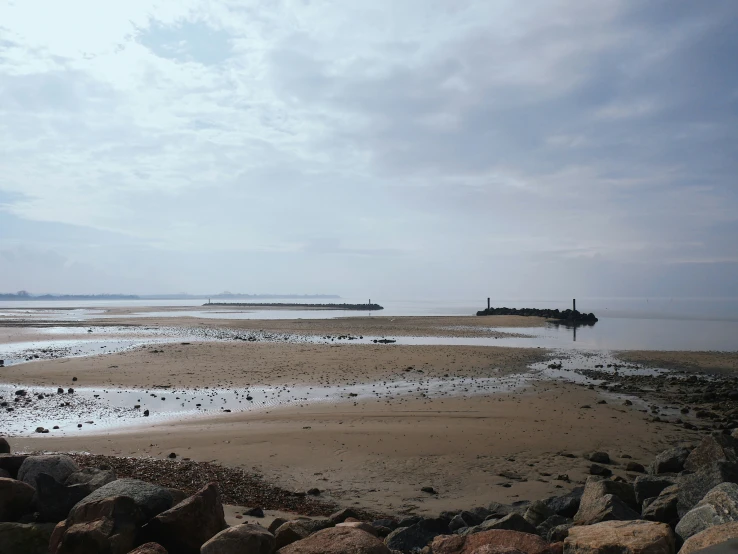 the beach has rocks along the shoreline to allow waves