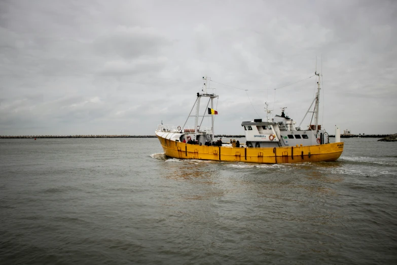 a yellow and white boat moving in the water