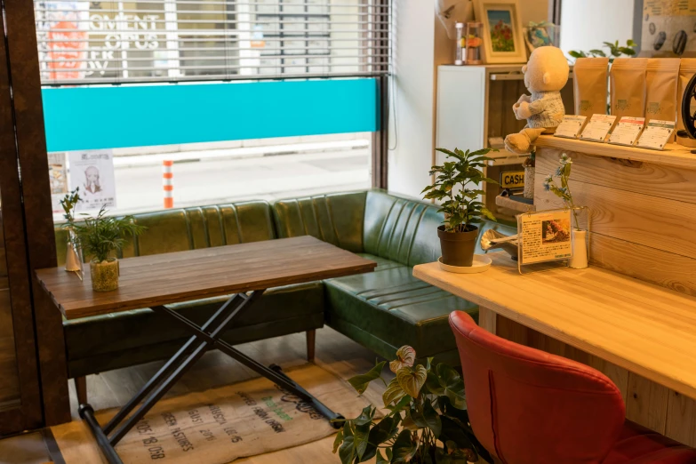 a bench and table inside a restaurant next to a window