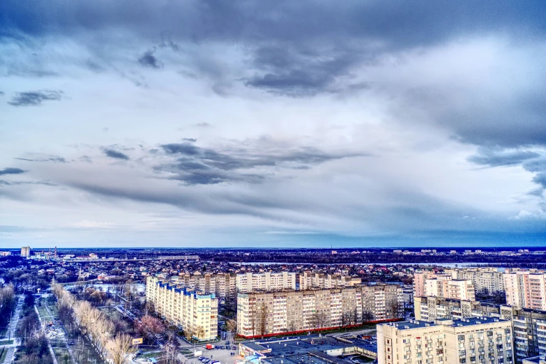 a cloudy sky above a city filled with buildings