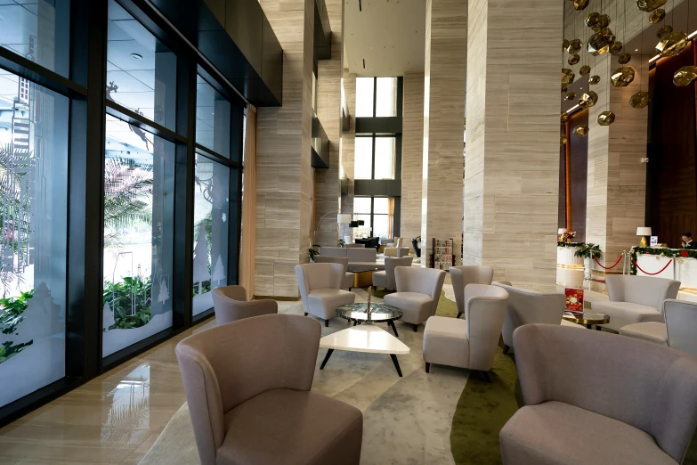 a fancy lobby is filled with white and tan chairs