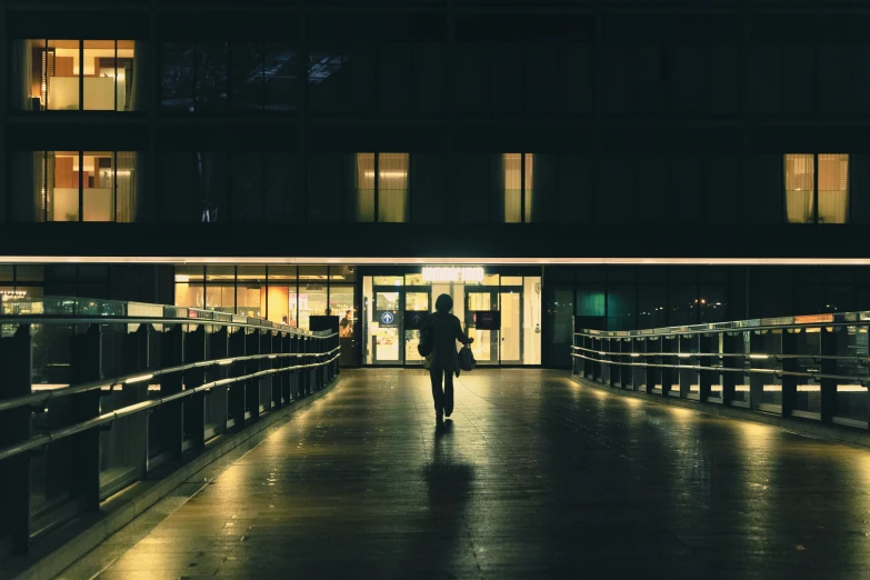 a person walks in a walkway with lights on