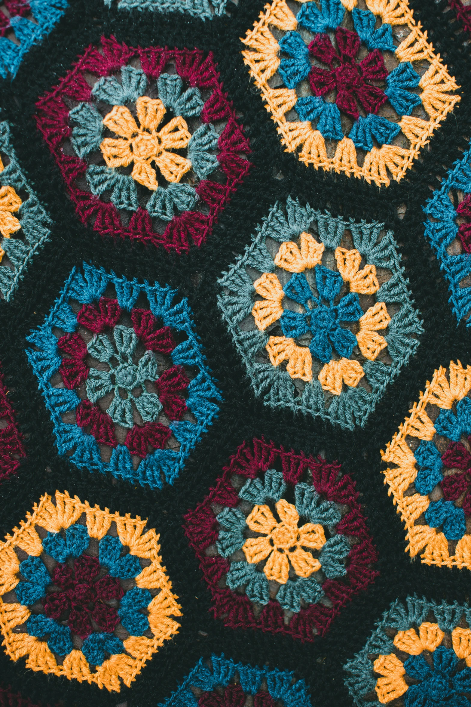 a multi - colored crocheted patch and circle design