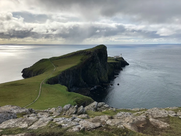 a rocky cliff on the edge of a body of water