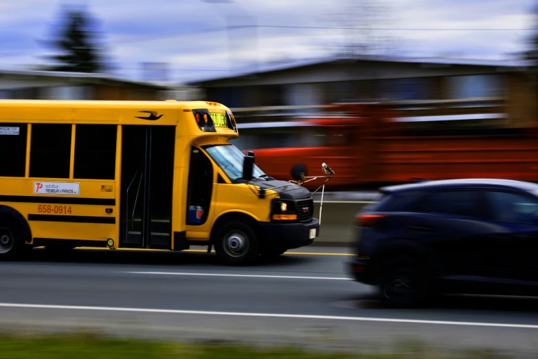 a large yellow school bus driving down a street