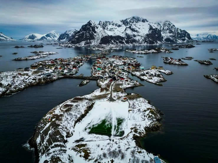 snow covers the landscape around this small fishing village