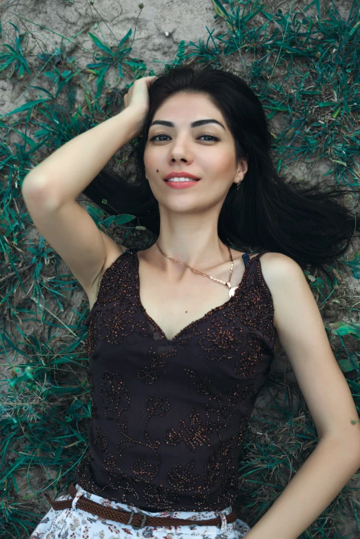 an image of a woman laying down with her hand on her hair