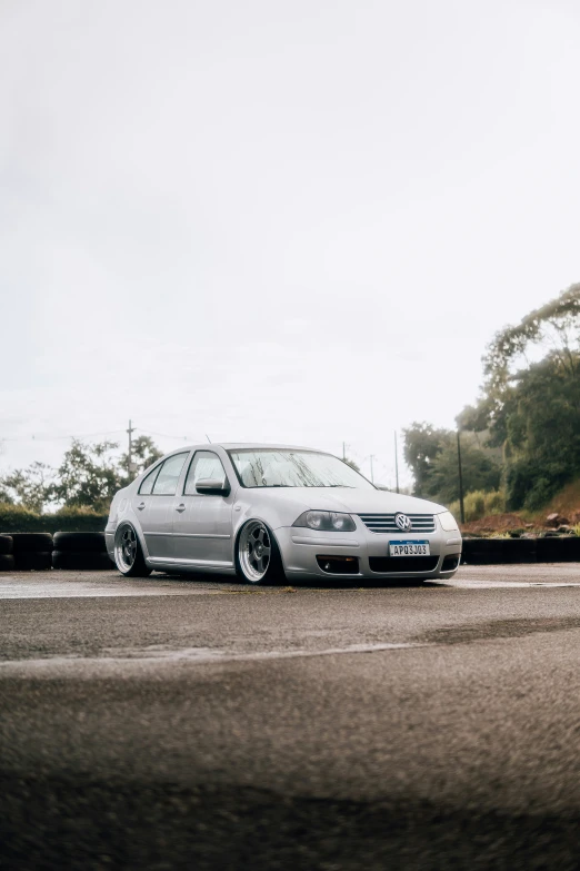 the car is parked near a concrete wall