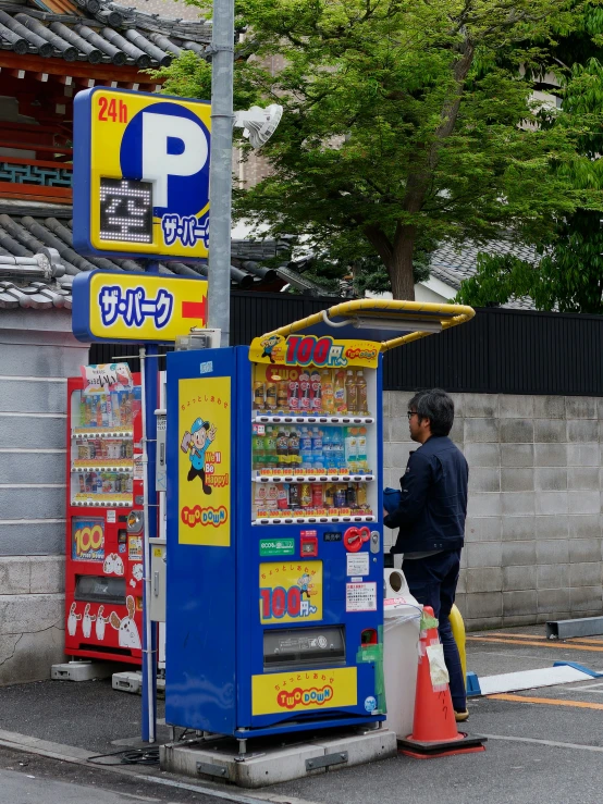 a man standing next to an electronic soda machine