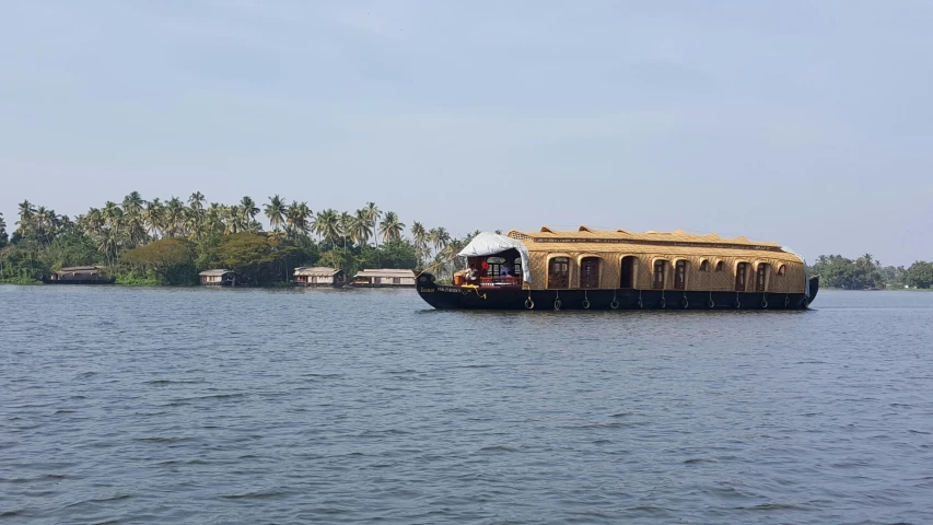 a large raft carrying two large wooden planks across the water