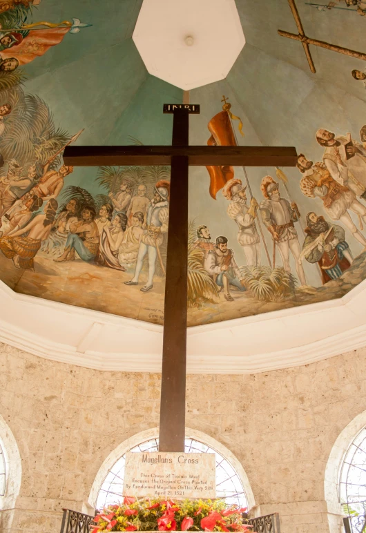 a large ornate cross on the inside of a church