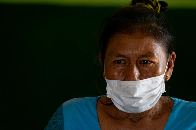 an asian woman with surgical face mask on