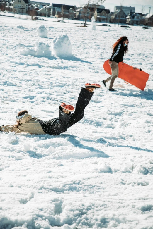 a person laying on top of snow covered ground