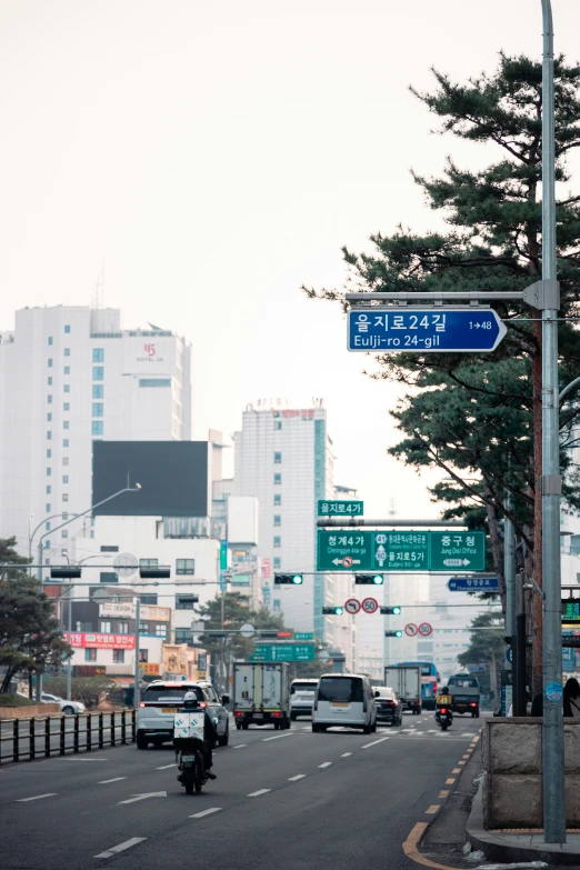 a city street with traffic and street signs