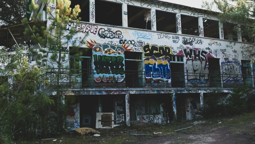 a multistory graffiti - covered building that's made from old windows