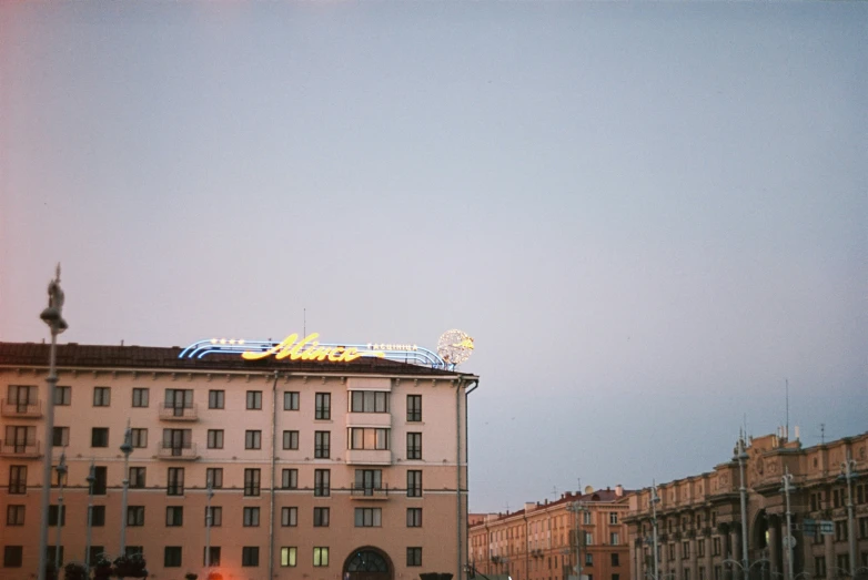 people are standing outside a large building at dusk