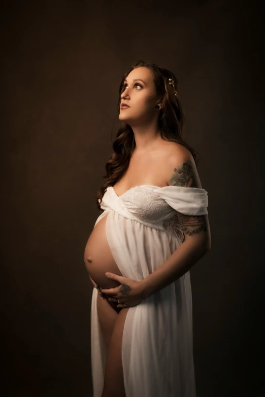 a pregnant woman is posing with her belly visible