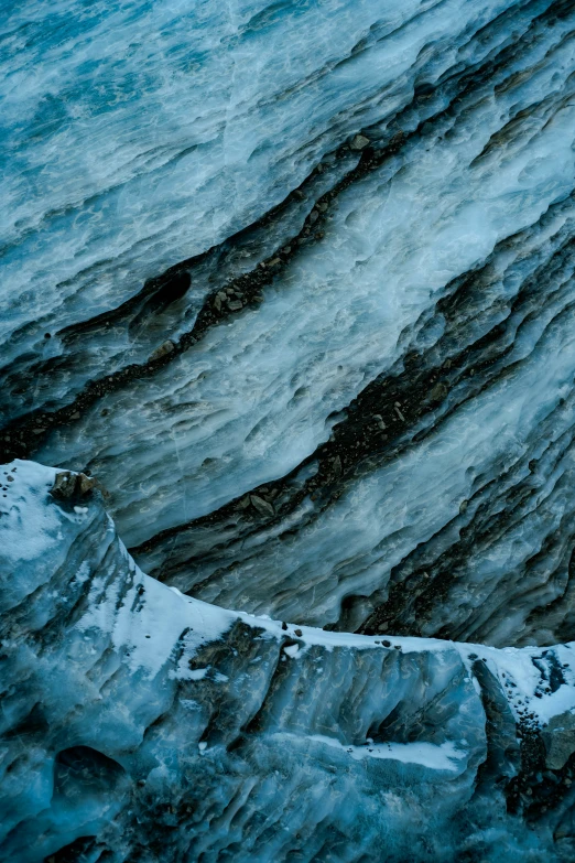 an aerial view of a frozen stream in the snow