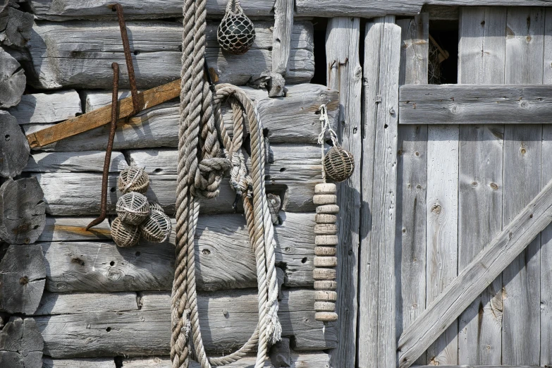 ropes hang from a door on wooden boards