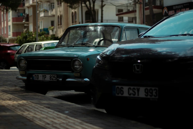 cars and bicycles parked in the street on a sunny day