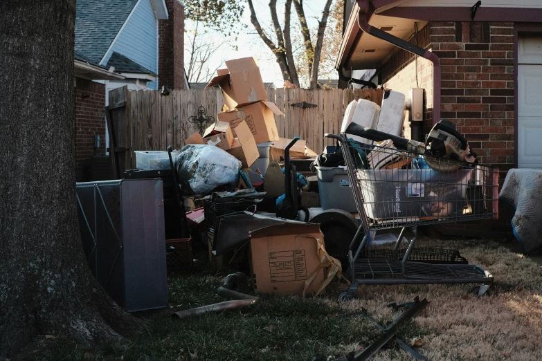 the trash is stacked into a pile next to the shed