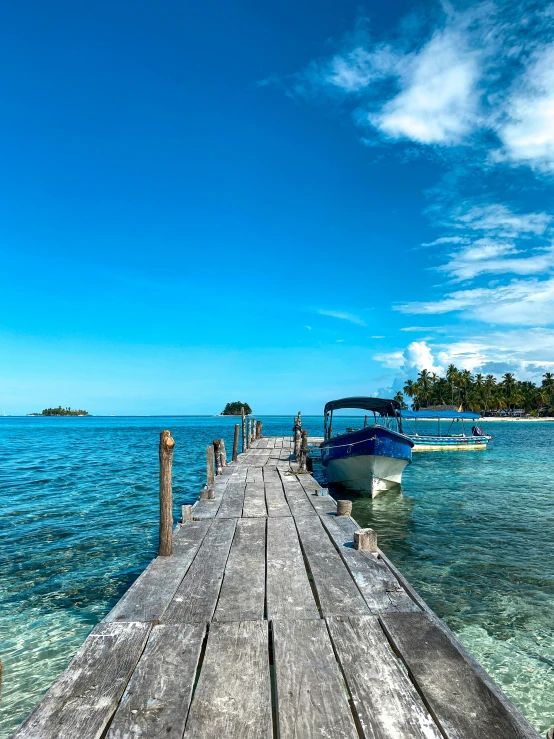 a pier with boats sitting in the water