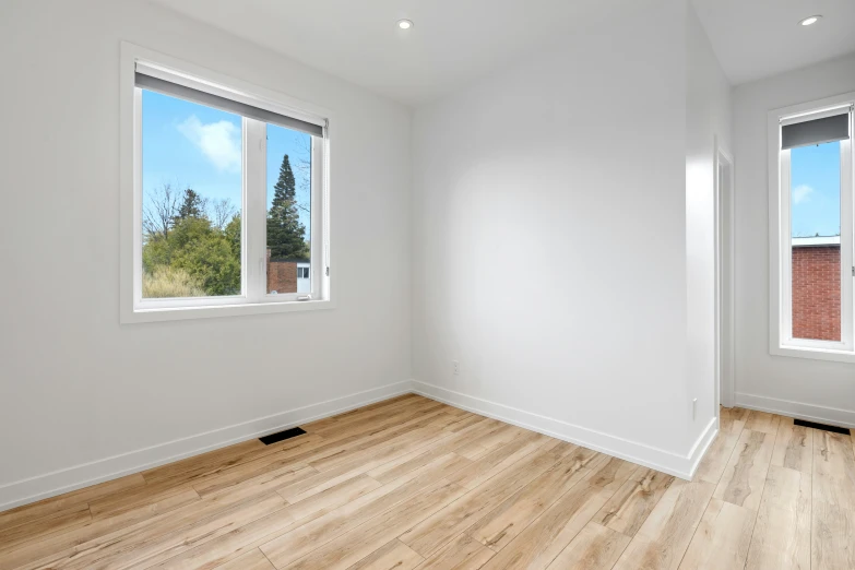 an empty living room with white walls and hardwood floors