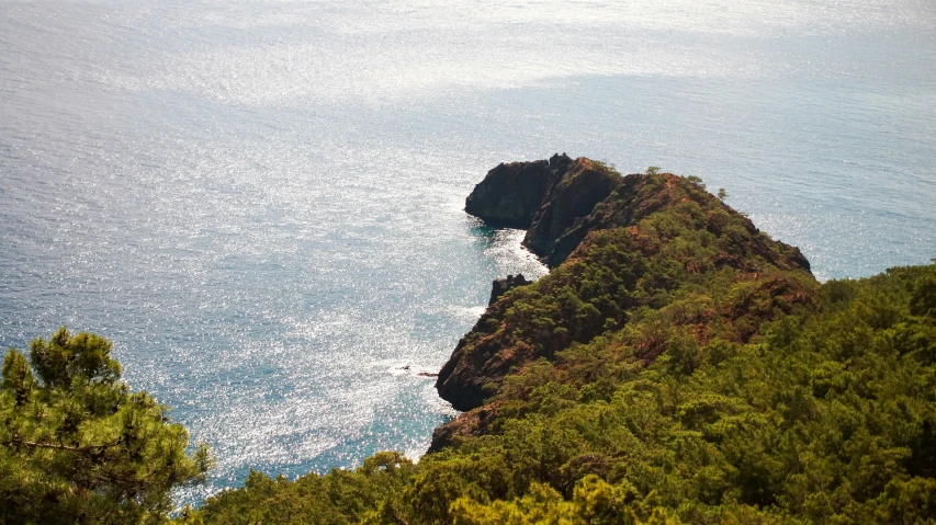 looking down on the ocean near a small hill