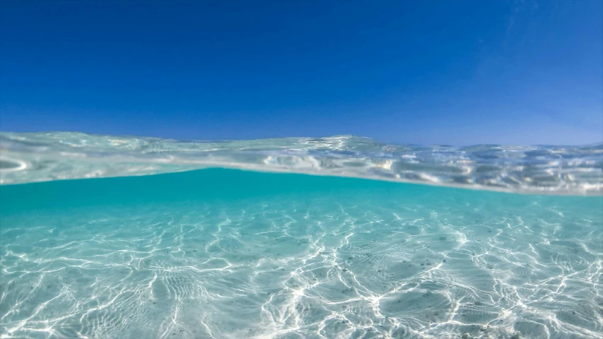 the clear water in the ocean is reflecting sunlight