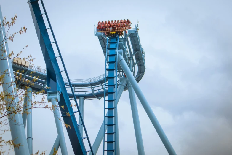 the roller coaster coaster rides in a cloudy sky