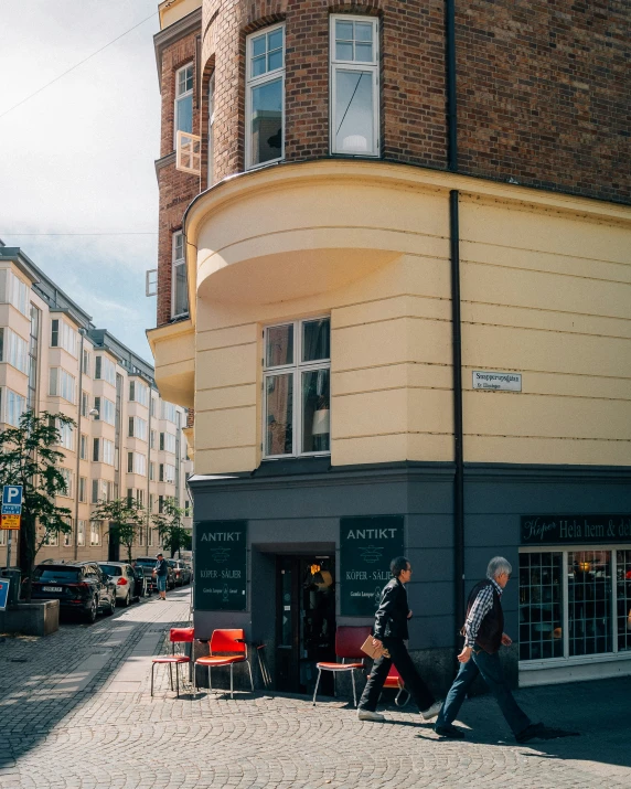 a man walking down the sidewalk with another man