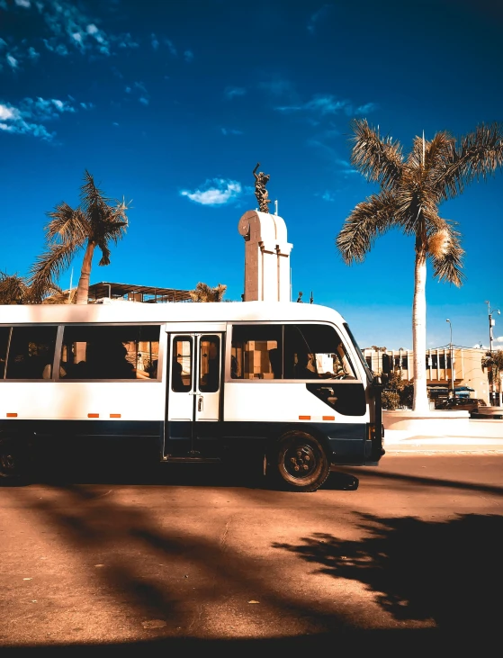 the large white bus is stopped by itself