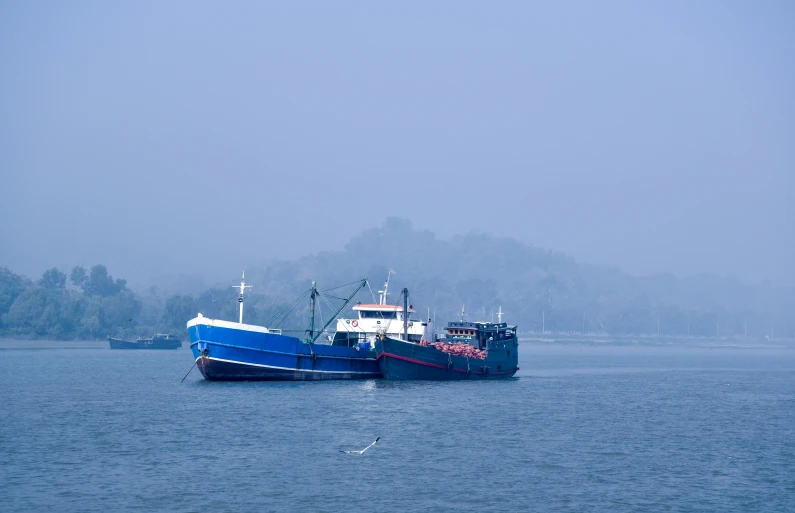 two boats that are sitting in the water