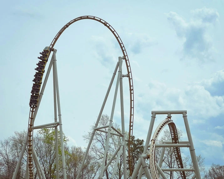 the roller coaster at cedar grove is seen through a thick frame