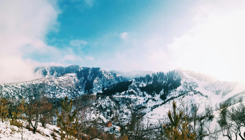 the sun shines on a mountain covered with snow