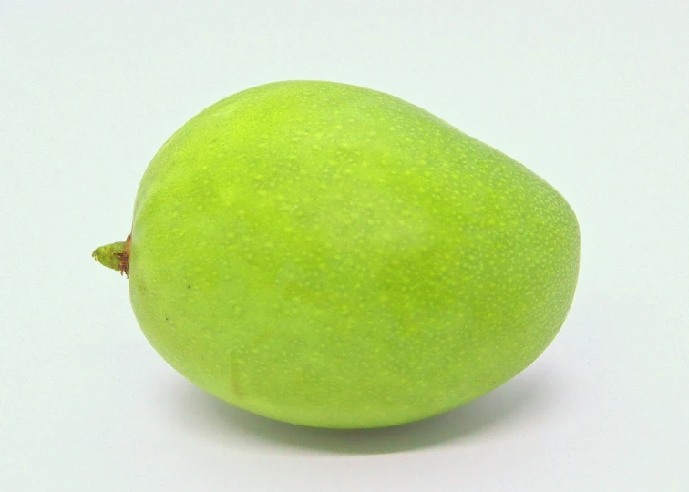 a green fruit is shown with no leaves