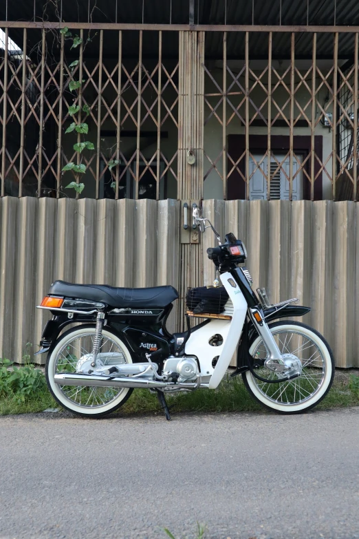 a motor scooter is parked by the side of the road