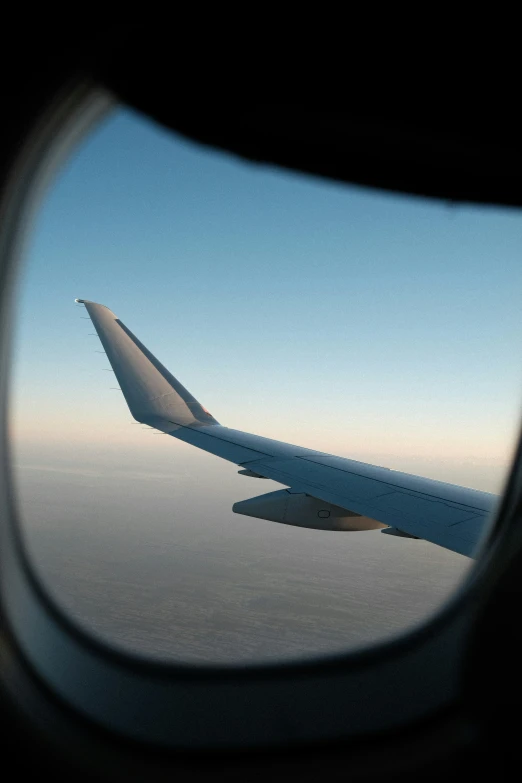 view from an airplane window looking at the wing
